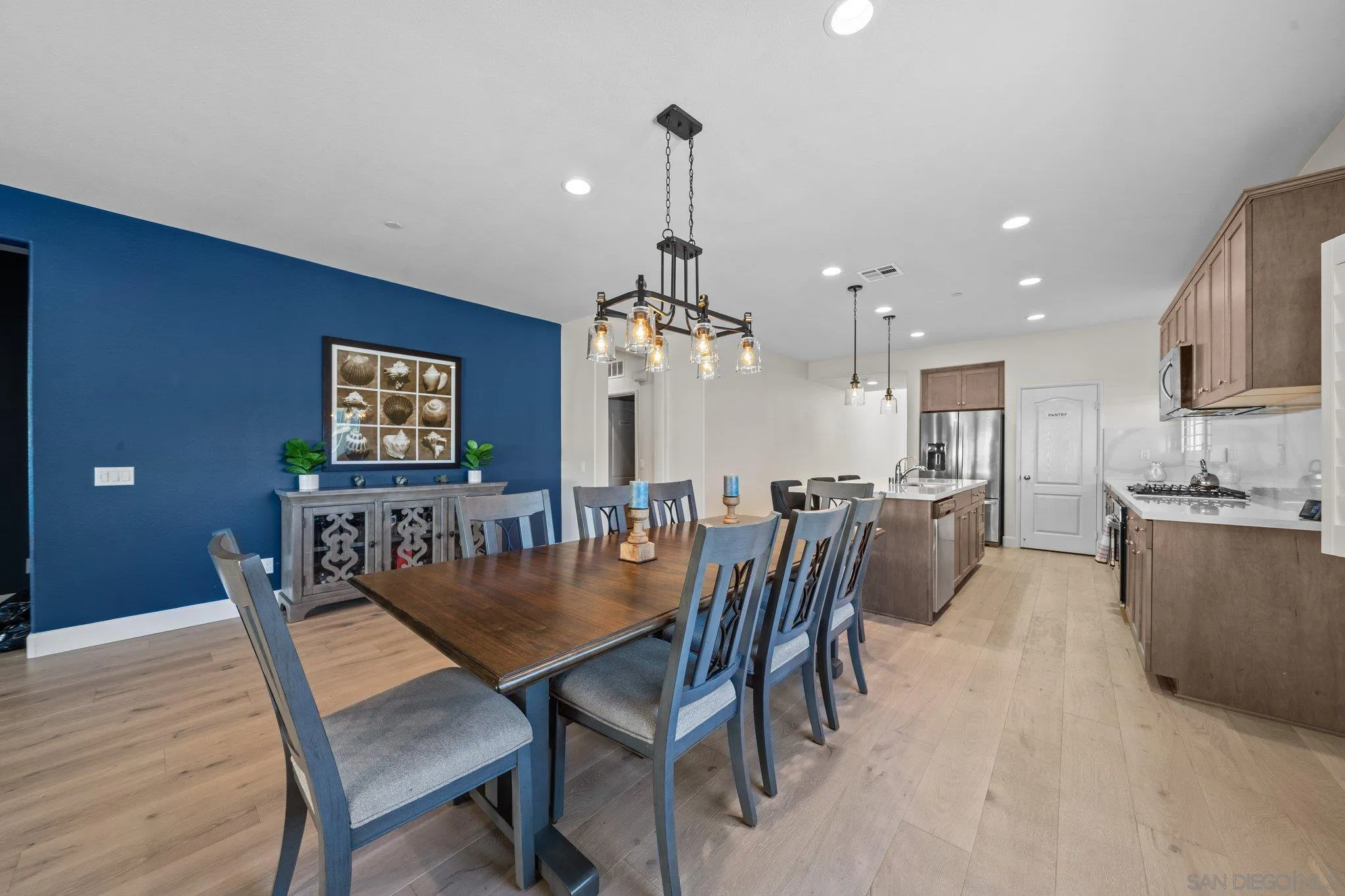 35778 Esperia Way Fallbrook, CA 92028 - Photo 26 of 44 a dining room with furniture a chandelier and wooden floor