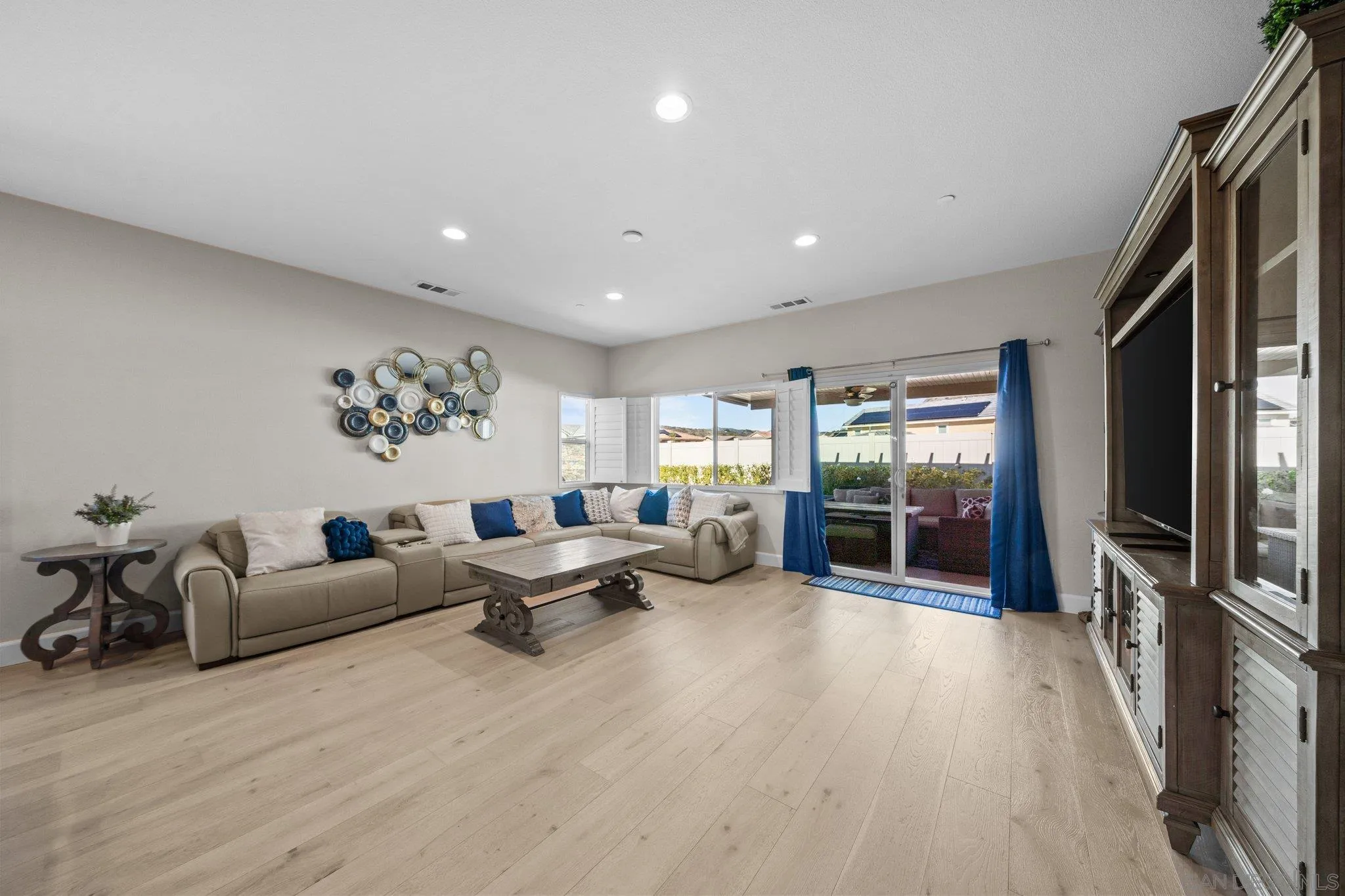 35778 Esperia Way Fallbrook, CA 92028 - Photo 27 of 44 a living room with furniture a large window and wooden floor