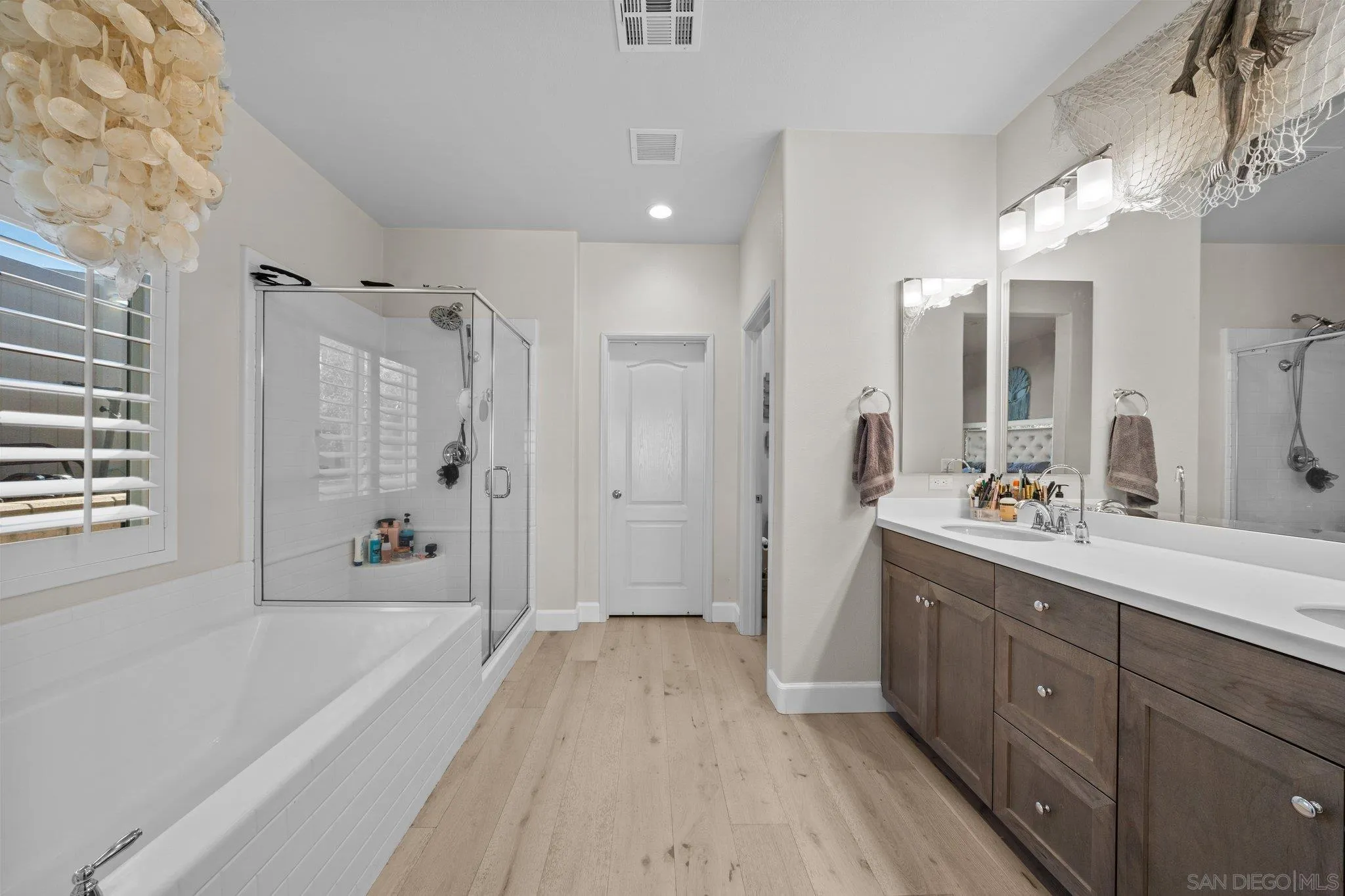 35778 Esperia Way Fallbrook, CA 92028 - Photo 35 of 44 a spacious bathroom with a double vanity sink a mirror a bathtub and shower