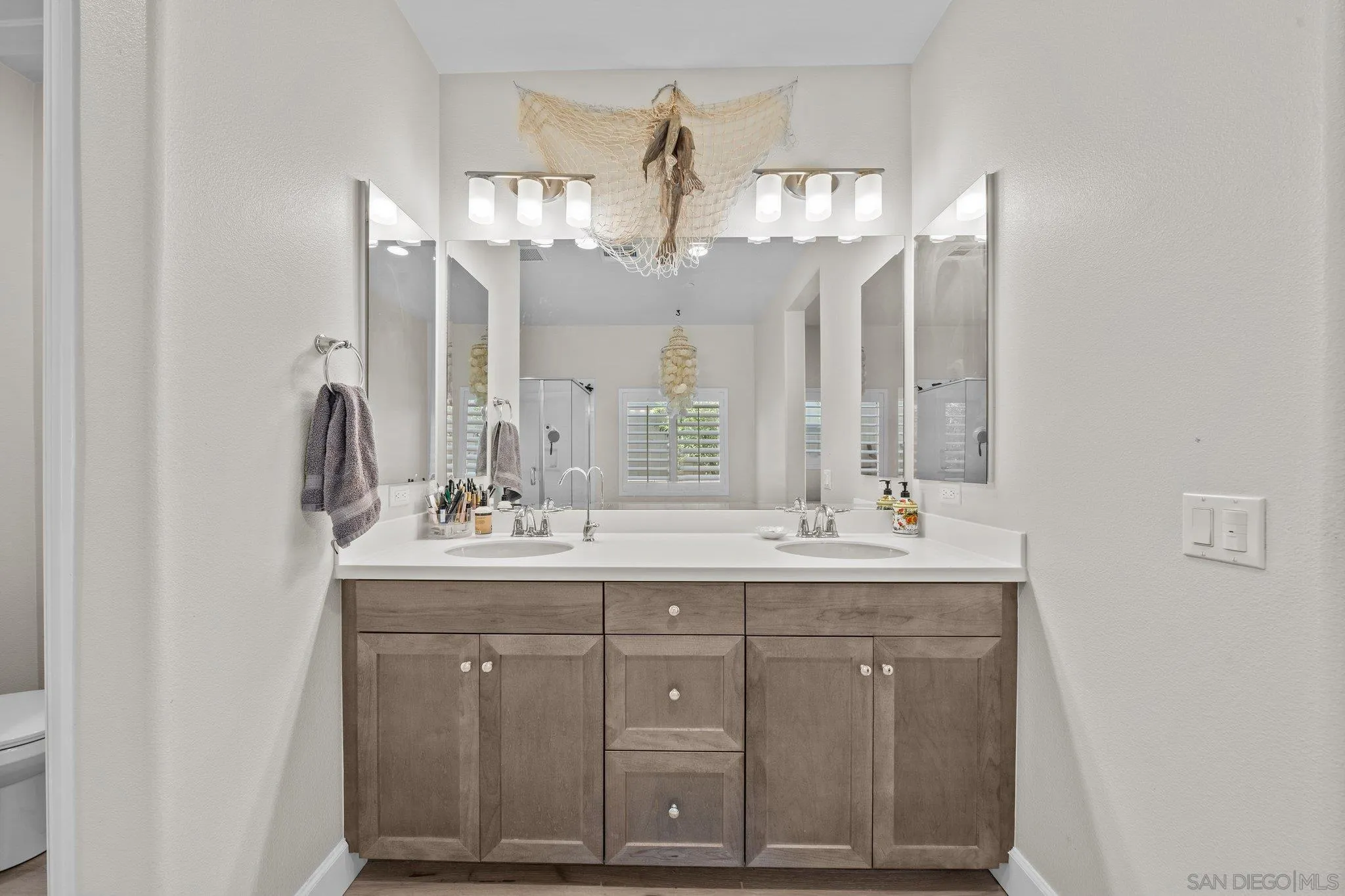 35778 Esperia Way Fallbrook, CA 92028 - Photo 36 of 44 a bathroom with a double vanity sink and a mirror
