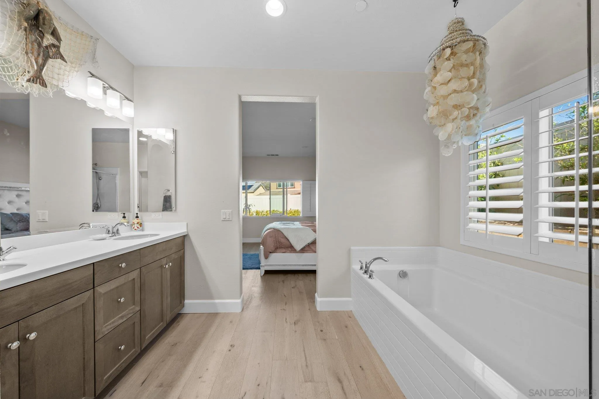 35778 Esperia Way Fallbrook, CA 92028 - Photo 38 of 44 a spacious bathroom with a bathtub double vanity and window