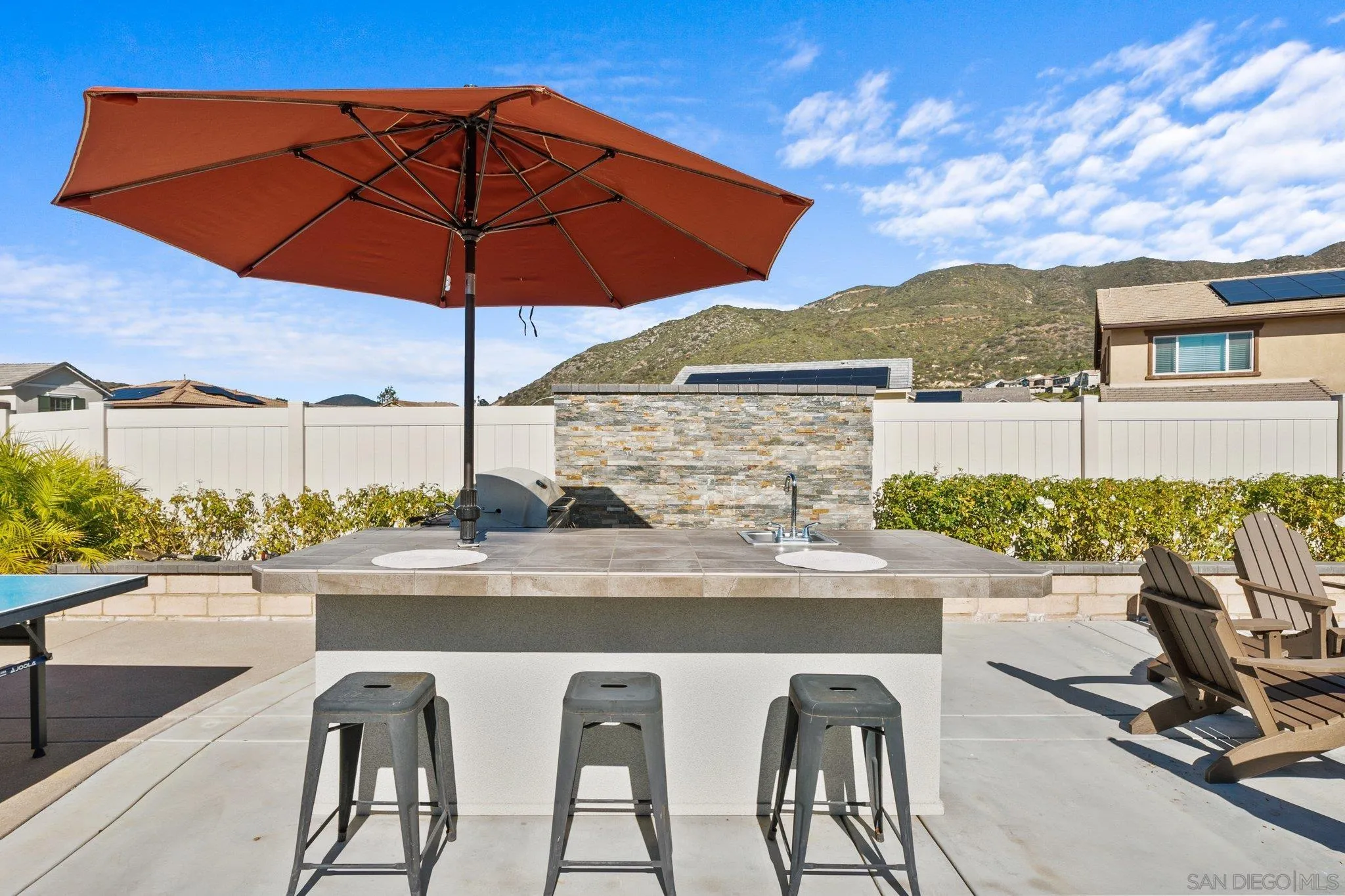35778 Esperia Way Fallbrook, CA 92028 - Photo 7 of 44 a view of a patio with a table and chairs under an umbrella