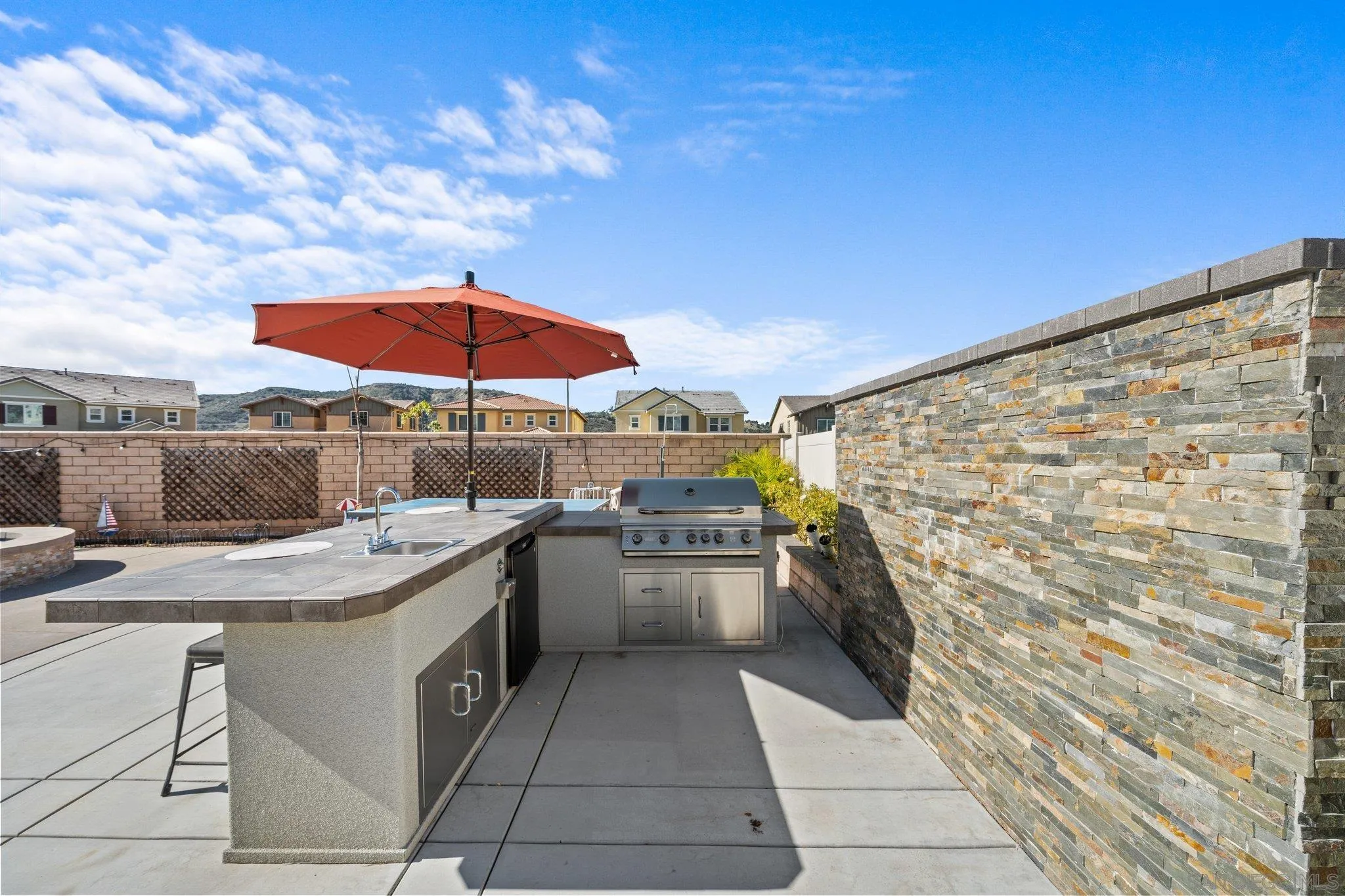 35778 Esperia Way Fallbrook, CA 92028 - Photo 8 of 44 a patio with a table and chairs under an umbrella
