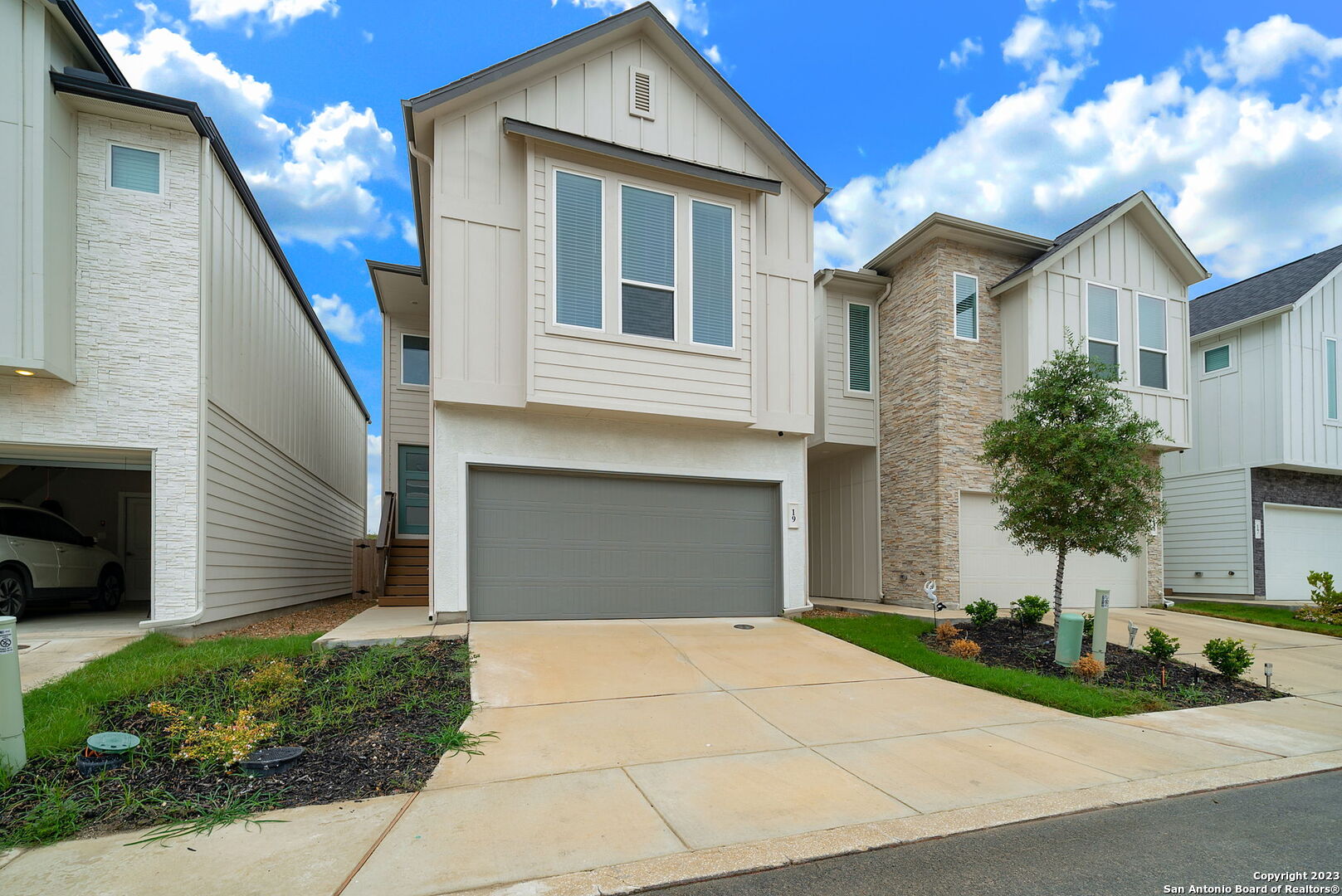 a front view of a house with a yard and garage