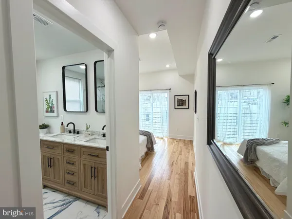 a bathroom with a granite countertop sink mirror and a bathtub