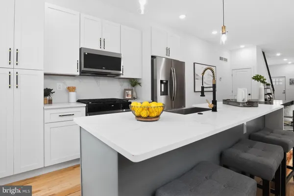 a kitchen with refrigerator and white cabinets