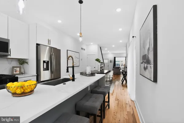 a large kitchen with stainless steel appliances lots of counter space and window