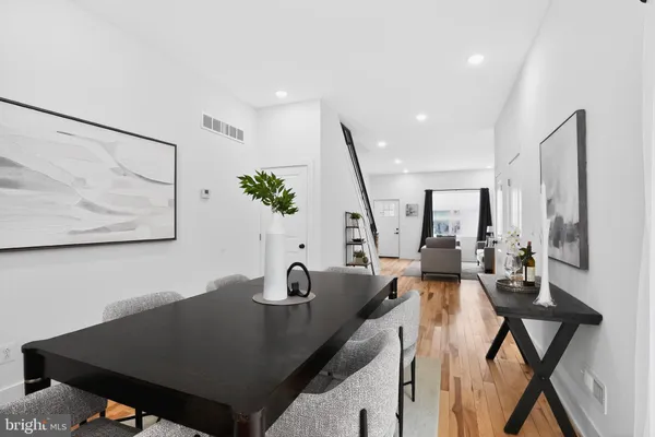 a view of a dining room with furniture and a potted plant