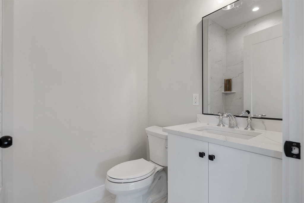 186 Bedford Street, Unit 204 Lexington, MA 02420 - Photo 5 of 10 a bathroom with a sink toilet and vanity