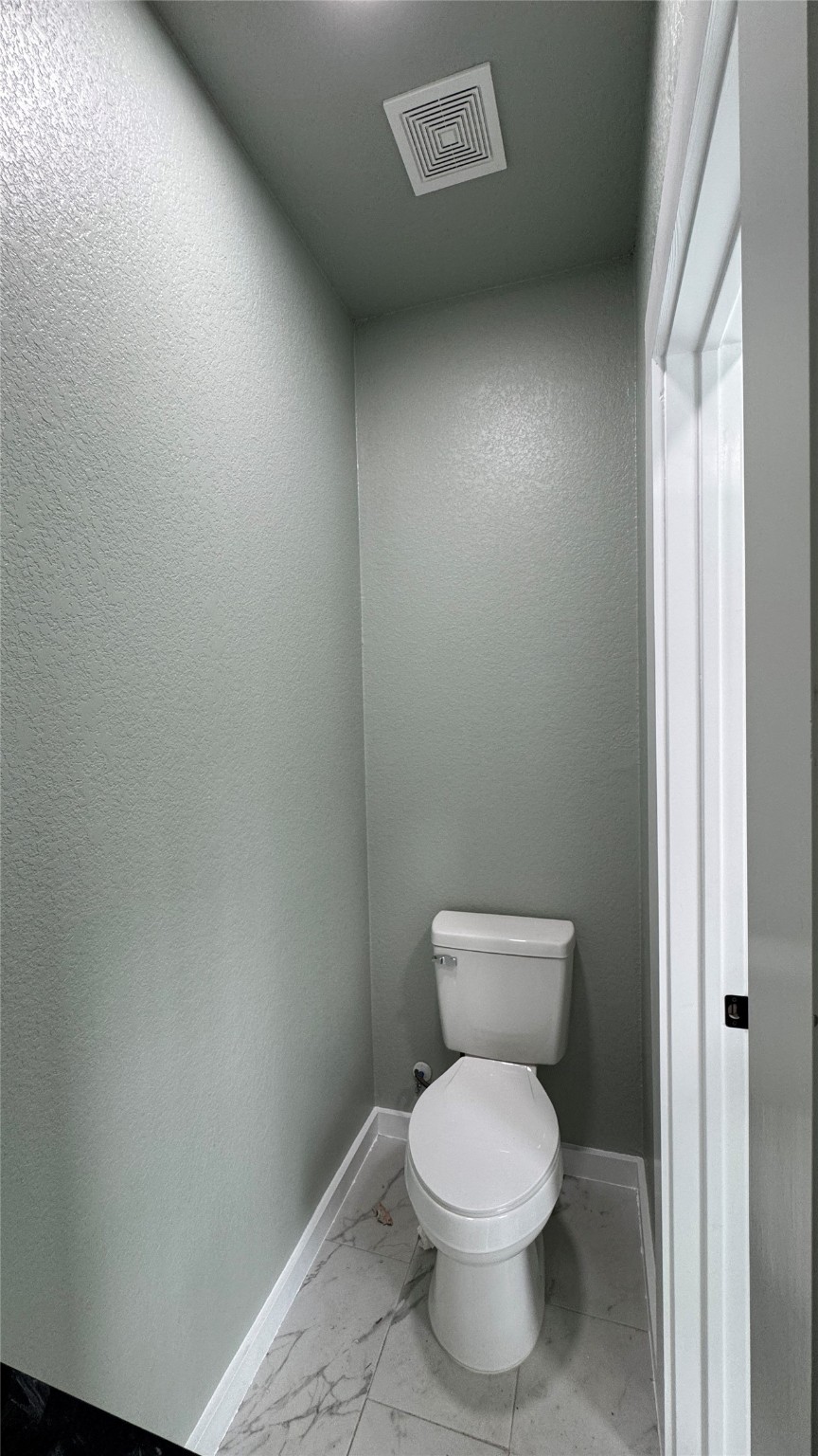 169 South 10th Street Conroe, TX 77301 - Photo 16 of 42 a white toilet sitting next to a white cabinet
