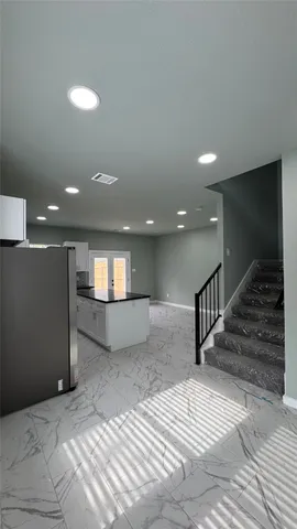 a white toilet sitting next to a white cabinet