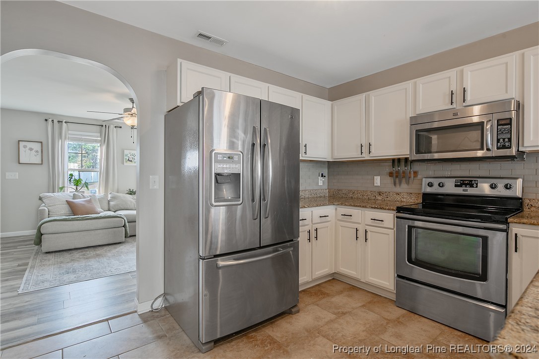 73 Loyalist Road Cameron, NC 28326 - Photo 15 of 42 a kitchen with stainless steel appliances a refrigerator stove and microwave
