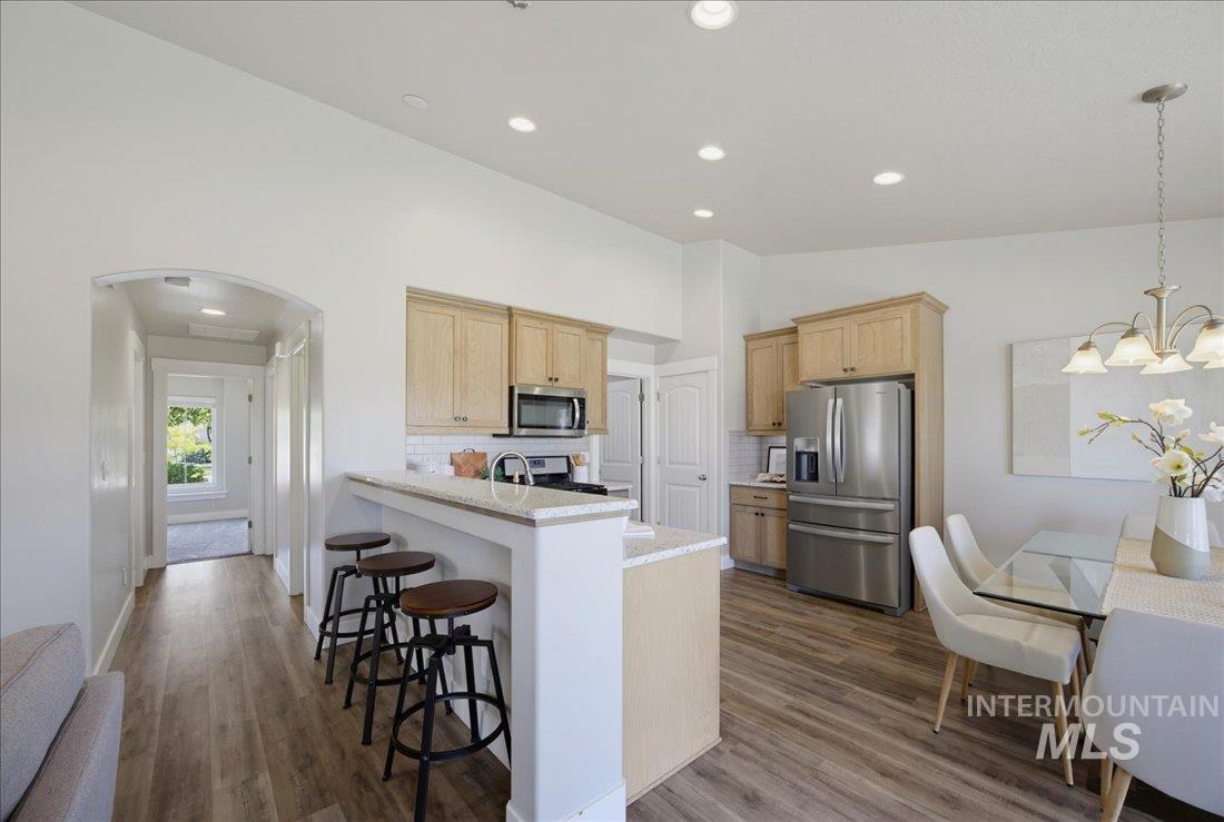 5317 West Lockner Street Eagle, ID 83616 - Photo 17 of 34 Featuring stainless appliances, quartz countertops, breakfast bar and walk-in pantry.