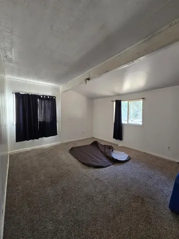 a room with a window and a ceiling fan