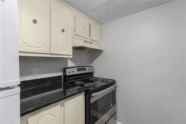 a stove top oven sitting inside of a kitchen