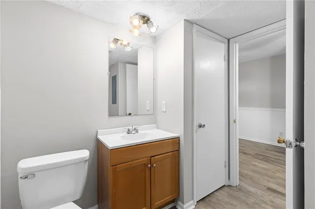 a bathroom with a toilet sink and mirror