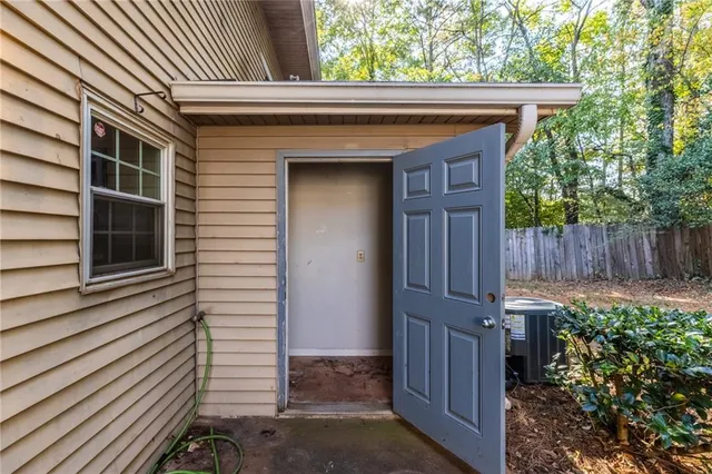 a view of a house with a yard and wooden fence