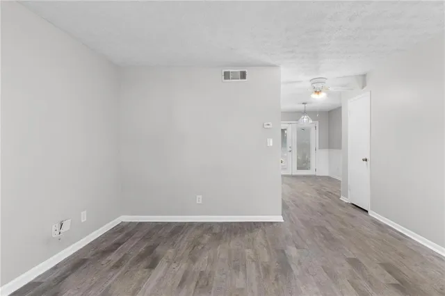 a view of a room with wooden floor