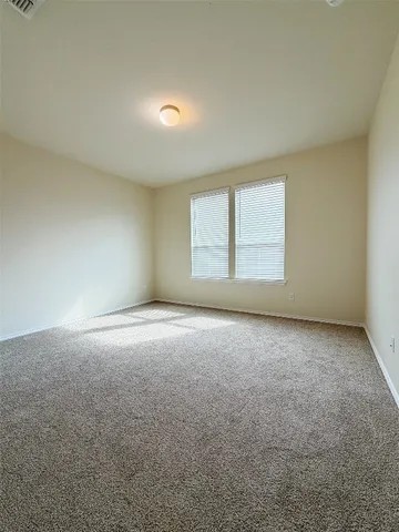 an empty room with a windows and closet