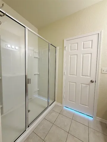 a bathroom with a glass shower door