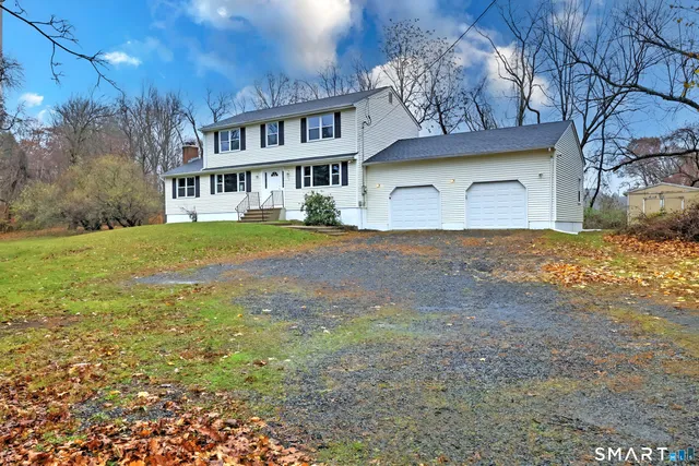 a front view of house with yard and trees