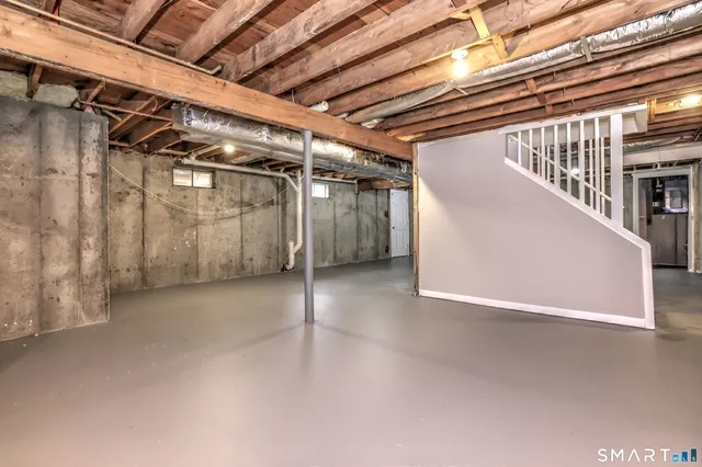 a front view of house with yard and trees in the background