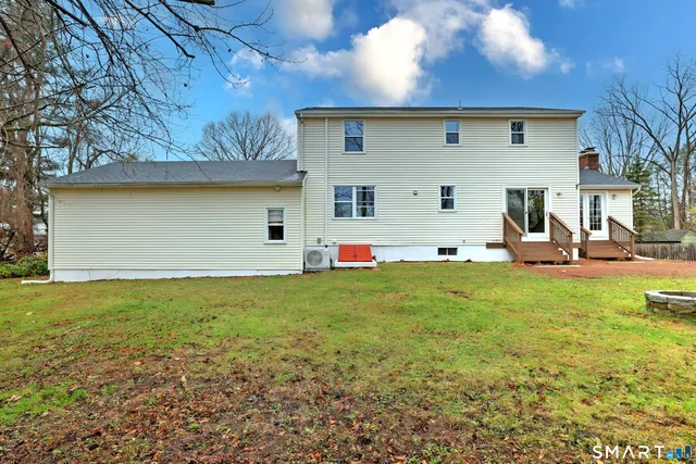 a view of a white house with a yard