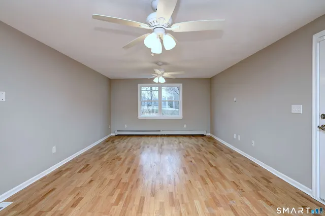 wooden floor in an empty room with a window