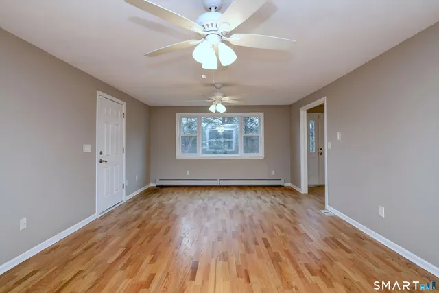 wooden floor in an empty room with a window