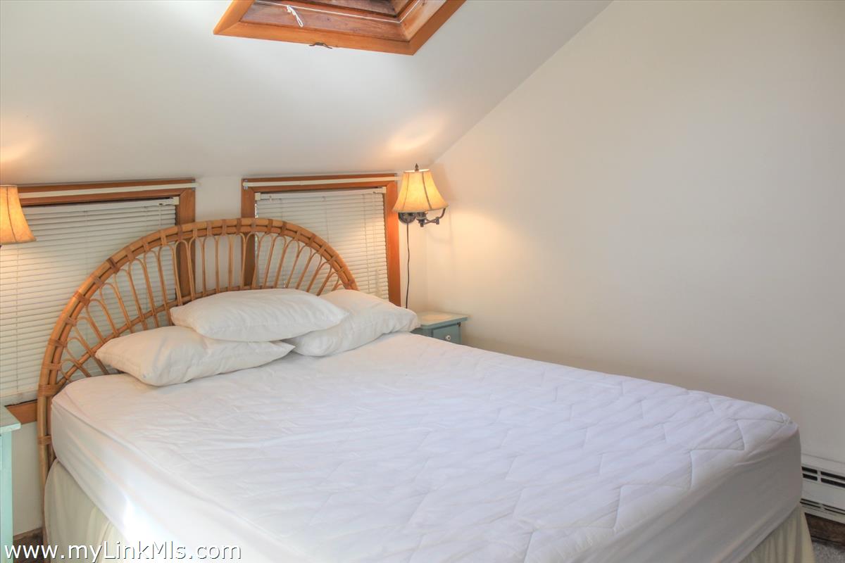 8 Sea Street Nantucket, MA 02554 - Photo 5 of 7 a bedroom with a bed and wooden floor