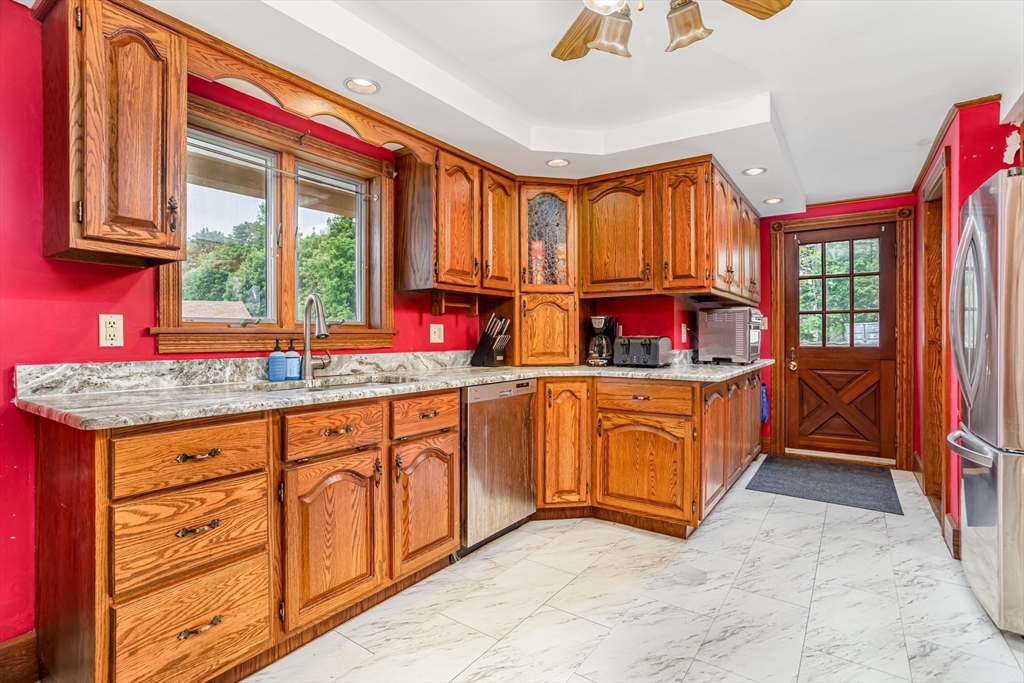 54 Charles Street Gardner, MA 01440 - Photo 4 of 40 a kitchen with stainless steel appliances granite countertop a stove a sink and a microwave