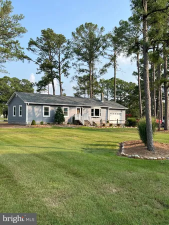 a front view of a house with swimming pool and outdoor seating