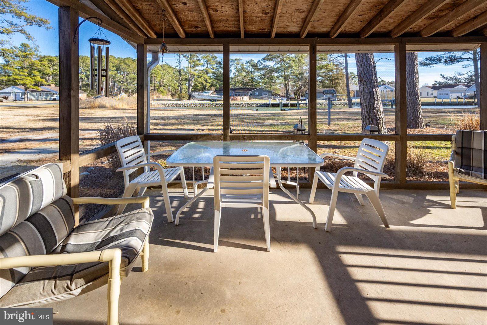 5241 Frances Road Marion Station, MD 21838 - Photo 107 of 146 a view of a dining room with furniture large windows and wooden floor