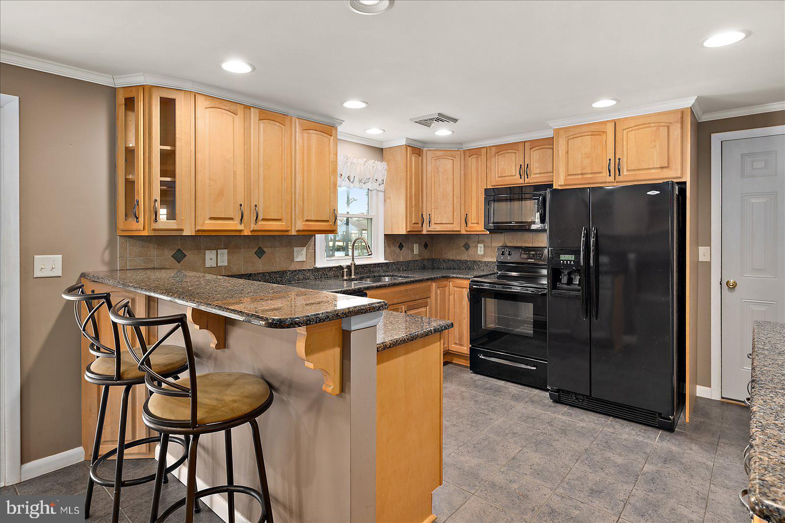 5241 Frances Road Marion Station, MD 21838 - Photo 118 of 146 a kitchen with stainless steel appliances granite countertop a stove a refrigerator a sink a stove with island and chairs
