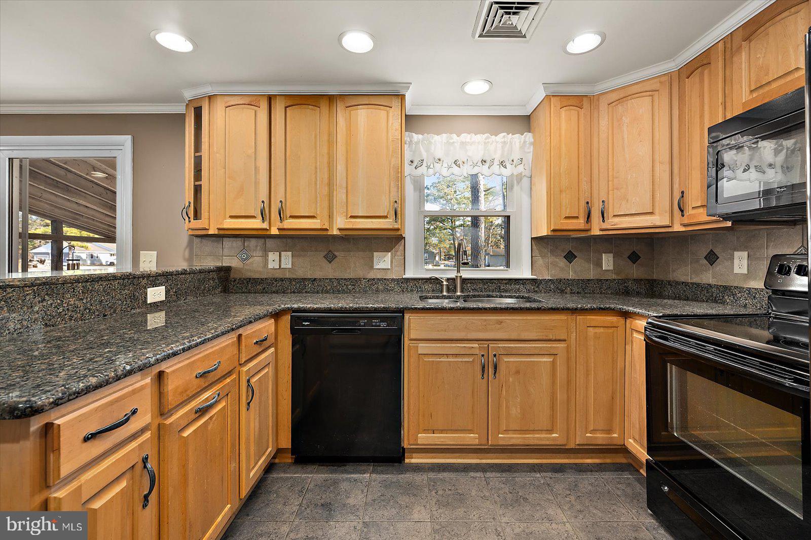 5241 Frances Road Marion Station, MD 21838 - Photo 127 of 146 a kitchen with stainless steel appliances granite countertop a stove a sink and a microwave