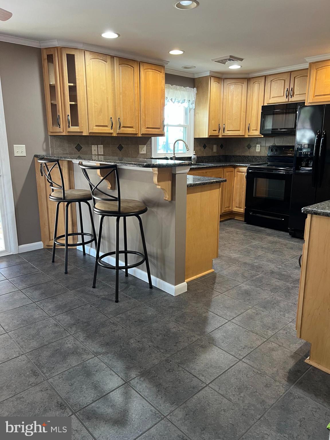 5241 Frances Road Marion Station, MD 21838 - Photo 18 of 146 a kitchen with stainless steel appliances granite countertop a stove top oven a sink a counter top space cabinets and a window