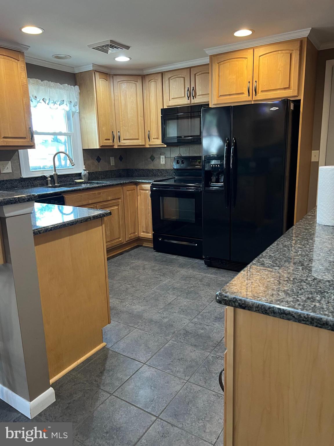 5241 Frances Road Marion Station, MD 21838 - Photo 29 of 146 a kitchen with stainless steel appliances a sink a stove a refrigerator a sink a counter top space and cabinets