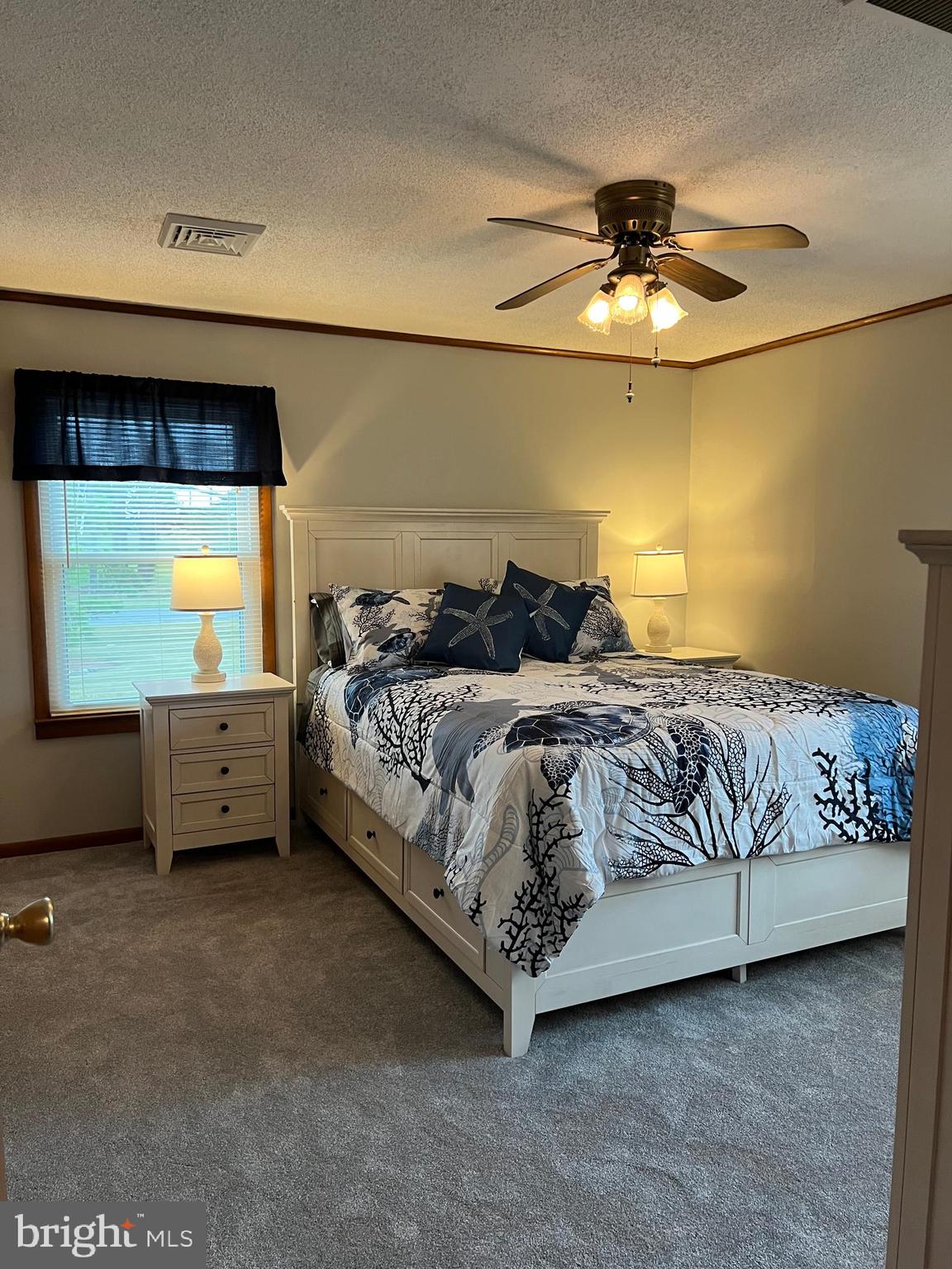 5241 Frances Road Marion Station, MD 21838 - Photo 35 of 146 a bedroom with a bed a couch and ceiling fan