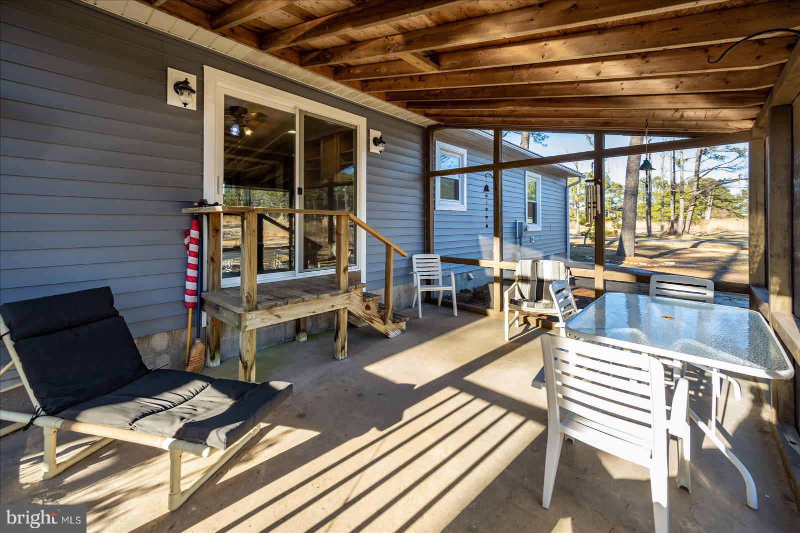 5241 Frances Road Marion Station, MD 21838 - Photo 100 of 146 a view of a patio with table and chairs with wooden floor and fence