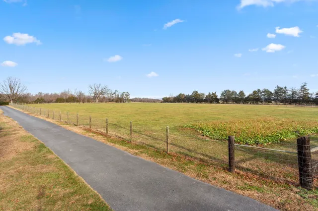 a view of a house with backyard and porch