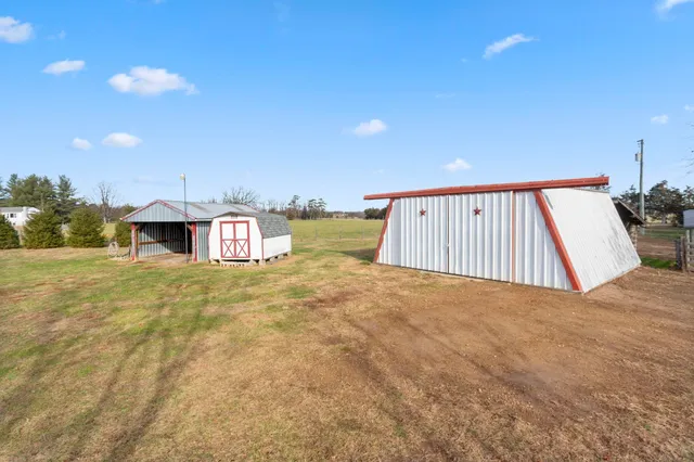 a kitchen with granite countertop a sink stove and microwave