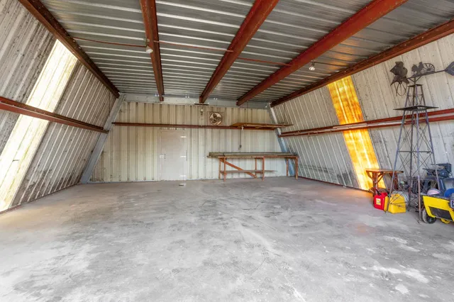 a kitchen with cabinets a sink stainless steel appliances and dining table