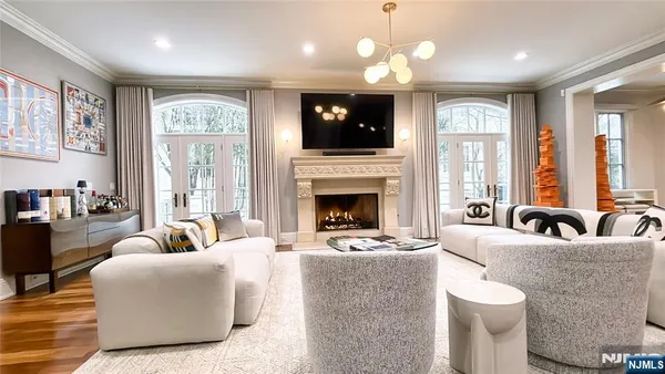a living room with furniture fireplace and flat screen tv
