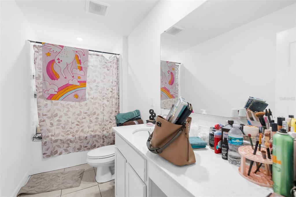 5637 East Tangelo Lane Inverness, FL 34453 - Photo 14 of 23 a bathroom with a toilet sink and shower curtain