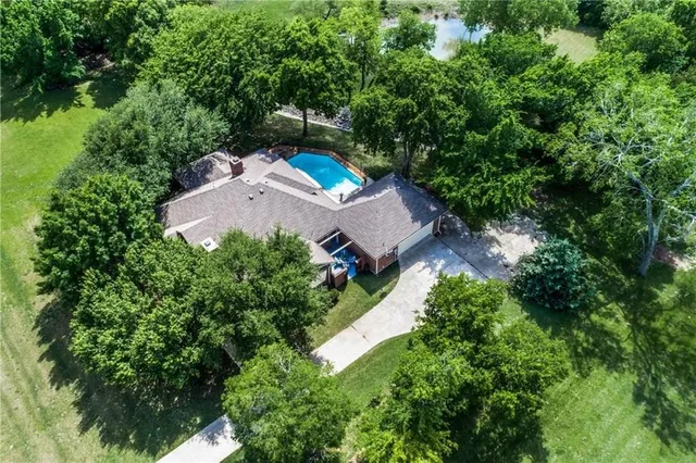 an aerial view of a house with a yard