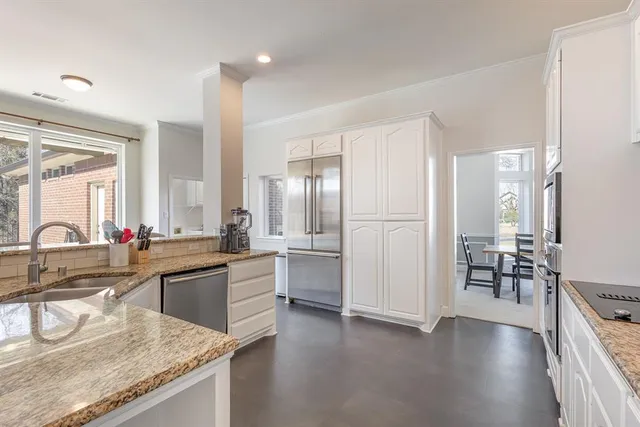 a living room with furniture and kitchen view