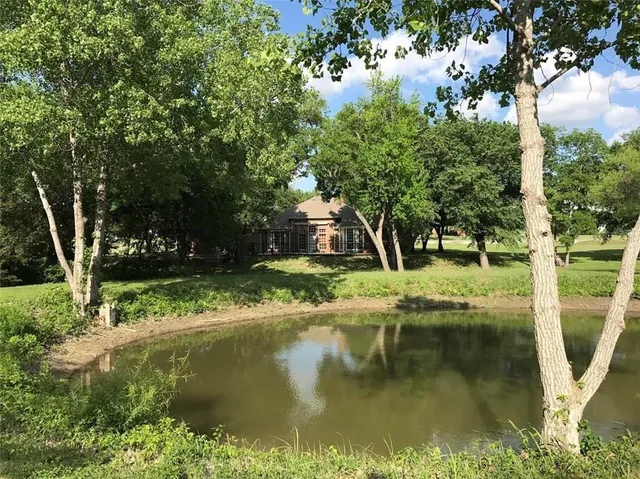 a view of a lake with a house in the background