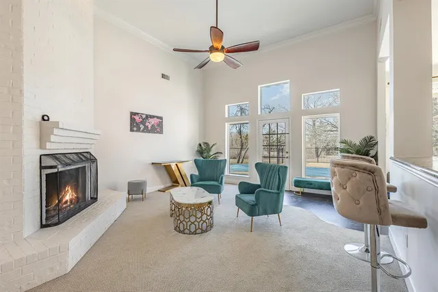 a living room with furniture and a floor to ceiling window