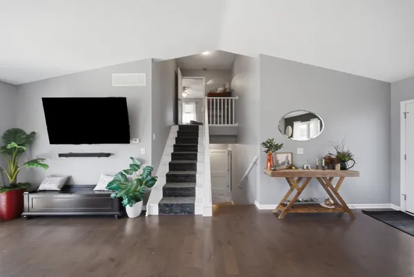 a view of a livingroom with furniture and a flat screen tv