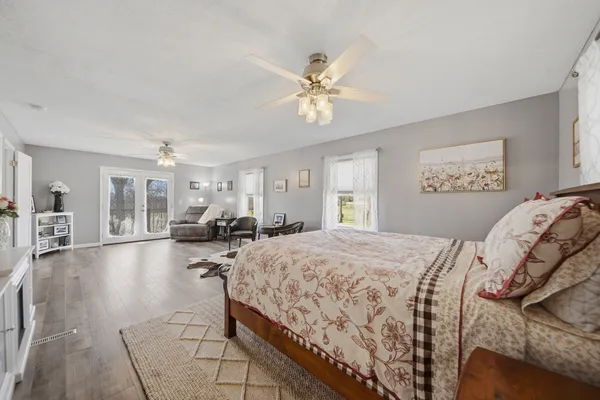 a bed room with a bed and ceiling fan